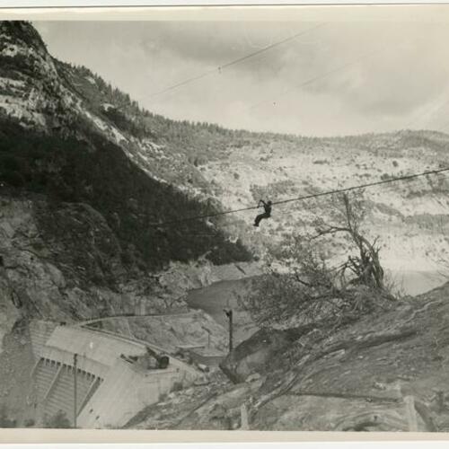 Worker on cable over the O’Shaughnessy Dam during construction