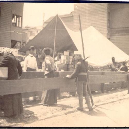 [Refugees receiving supplies at a supply camp]