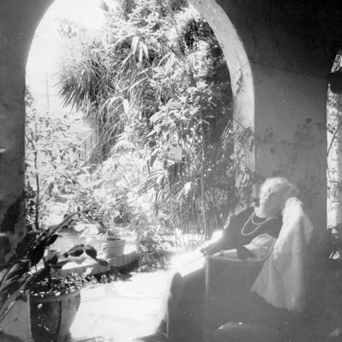[Annie Laurie sits in garden with book]