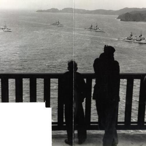 [Sightseers on the Golden Gate Bridge watching Navy ships enter San Francisco Bay]