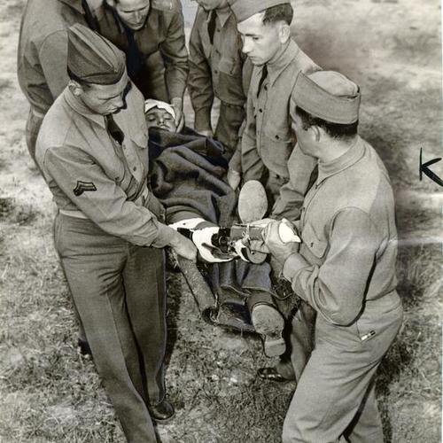 [Private Edward Wax being carried on a stretcher during first aid training at the Presidio]
