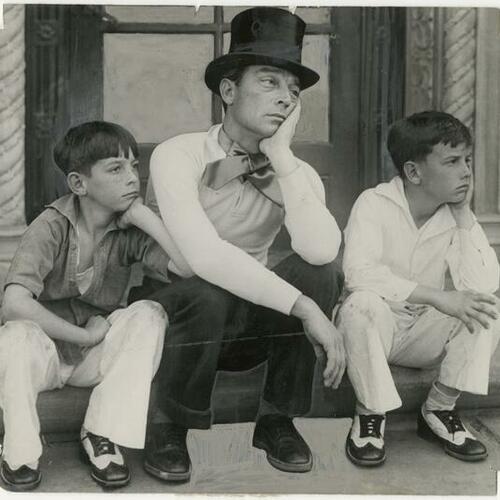 Buster Keaton in hat sitting between his two sons Joseph and Robert