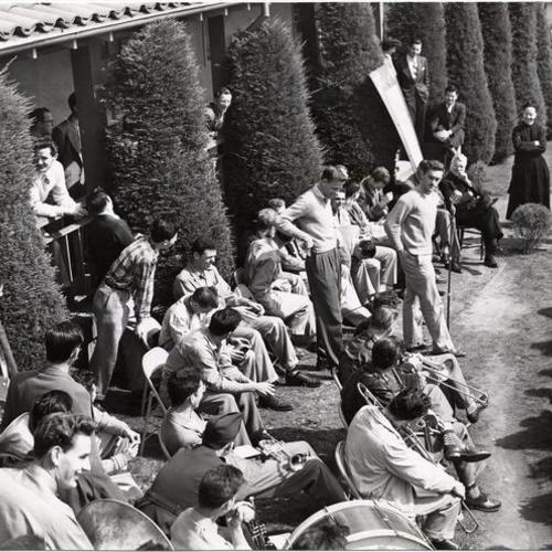 [Members of the school basketball team sitting outdoors on the University of San Francisco campus]