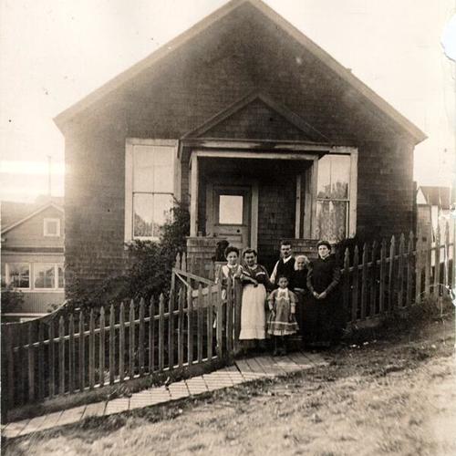 [Unidentified family posing for a picture outside of a home in Visitacion Valley]