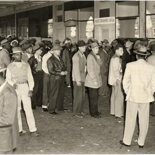 [Longshoremen lined up at the Ferry Building to collect checks for retroactive pay increases]