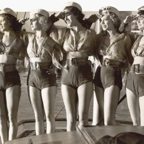[Nautical girls, Betty Scheibel, Ruth Hazen, Ethel Wagner, Jerry LeDere, and Claire Adell saluting on boat as part of opening ceremony for San Francisco-Oakland Bay Bridge]