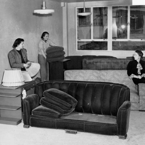 [Mrs. Reed O. Hunt, Mrs. Charles Dreifus Jr. and Mrs. Bela V. Low-Beer arranging furniture]