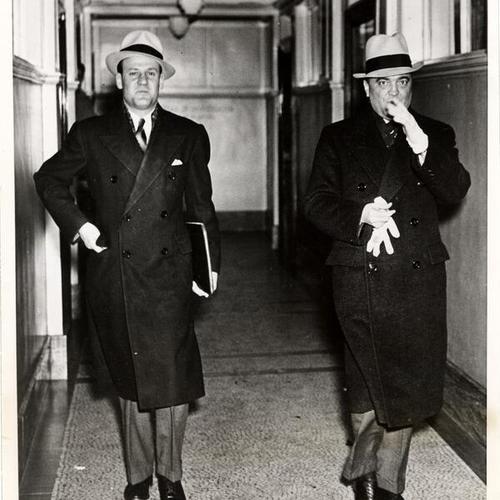 [J. Edgar Hoover (right) leaving the Federal Bureau of Investigation office in St. Paul, Minnesota, with unidentified agent]