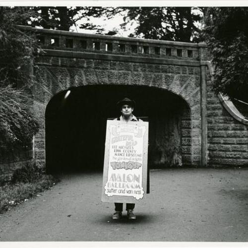 [Haight Ashbury - man carrying a sign advertising the Grateful Dead near Stanyan Street in Golden Gate Park]