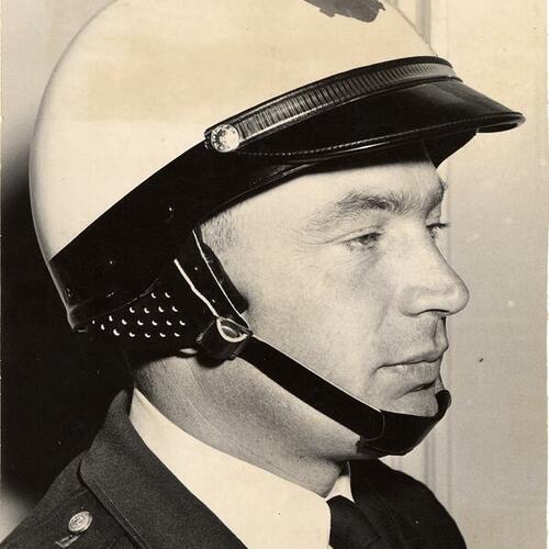 [Patrolman Edward Rose modeling new crash helmet]