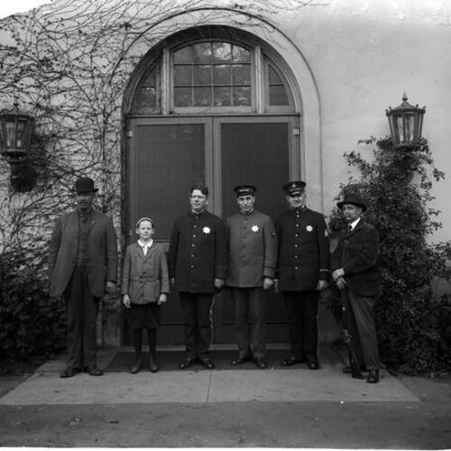 [San Francisco Police Officers and Sergeant Ross stand in front of Park Police Station with three others in civilian dress]