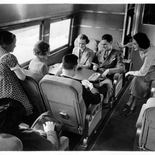 [Group of people playing cards on the "City of San Francisco" streamlined train]