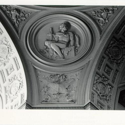 [Figure of a man with sword engraved on the wall of the Rotunda of City Hall]