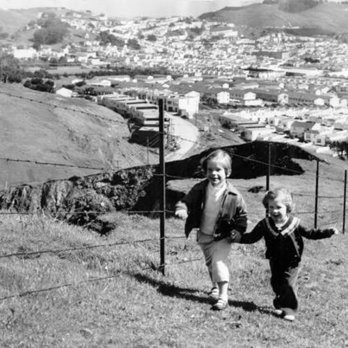 [Two children, Jane and Doris Hammarstedt, playing near an abandoned quarry in Visitacion Valley]