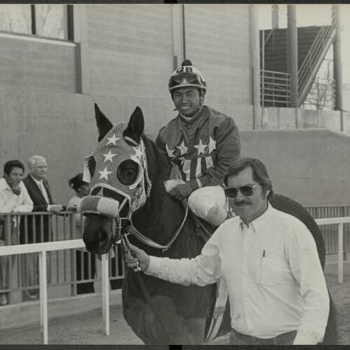 Vietnamese Jockey Bui Quyet on horse "Khalyourpleasure" with owner Thomas J. Thomas