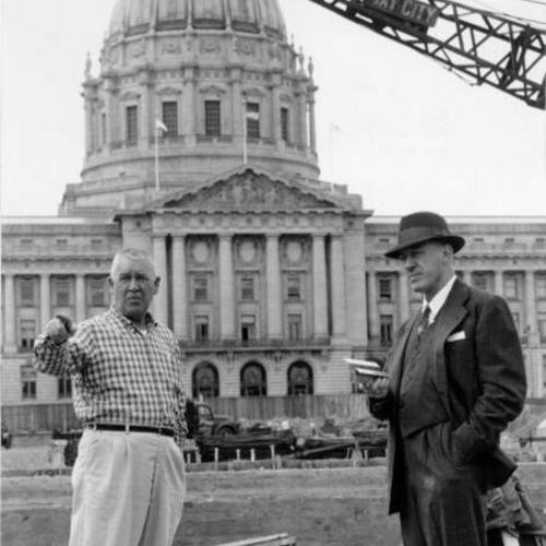 [Joe Clark and Sherman Duckel standing at the nearly completed construction site of Mole Hall (later Brooks Hall)]