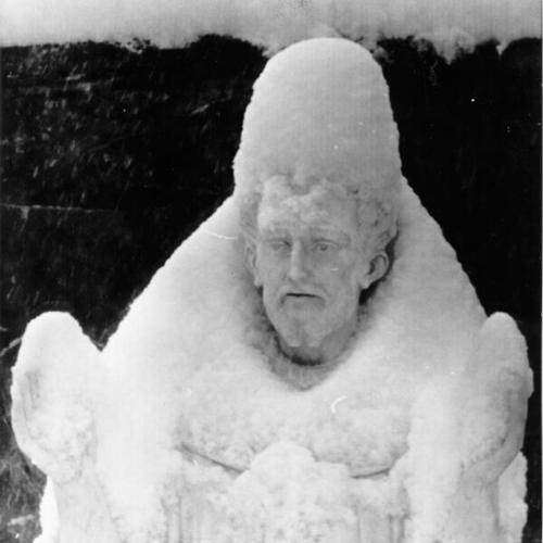 [Snow covered statue of Saint Francis of Assisi]