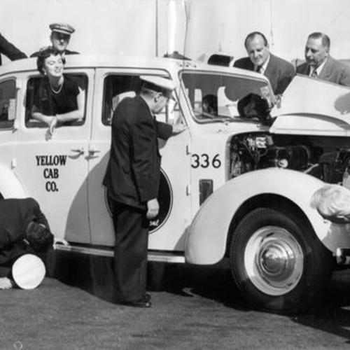 [Yellow Cab Company drivers and executives examining a newly purchased automobile]