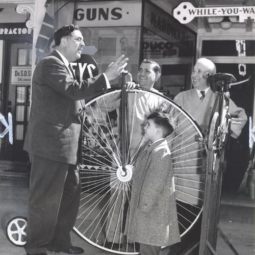[J. A. Giuffre talking to Vincent, Albert and Emil Borelli outside the Borelli Hardware and Sporting Goods Company at 4537 Mission Street]