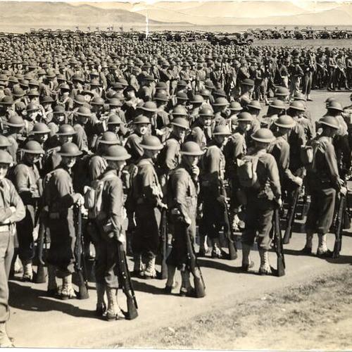 [Members of the Thirtieth Infantry shown at ease during a parade at Crissy Field in the Presidio]