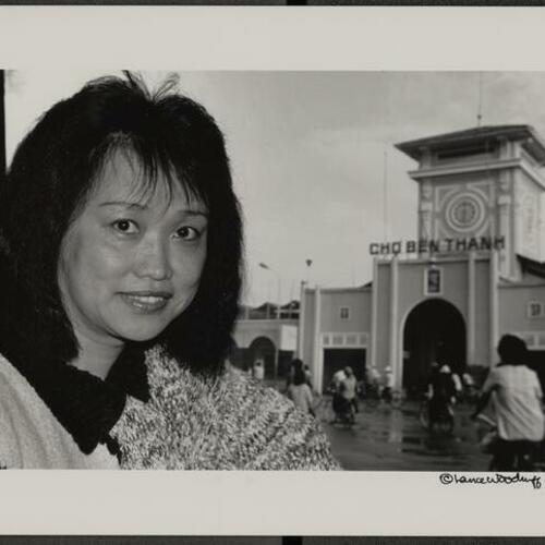 Betty Chan in front of photo she took of Central Market in Ho Chi Minh City
