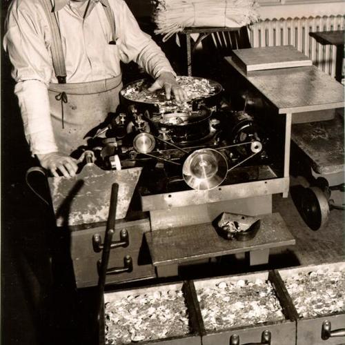 [Employee Andrew Jackson Baker operating a coin counting machine at the U. S. Mint in San Francisco]