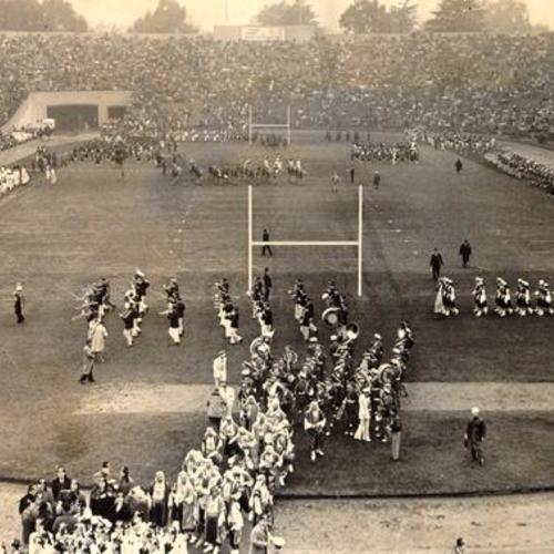 [Marching bands playing for crowd at a football game at Kezar Stadium]