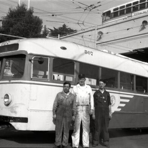 [John Gerrard Graham with Potrero Shop carpenter Henry Ute and Al Dinatali in front of Muni trolley coach 507]