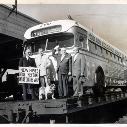 [Mayor Elmer Robinson, two other city officials and a representative of the Mack Truck Corporation posing with a newly purchased diesel-powered Muni bus]