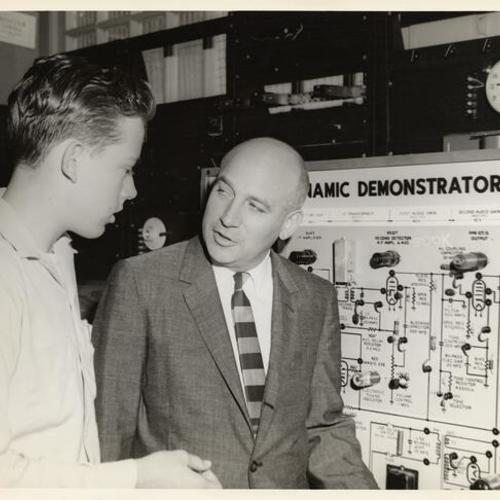 [J. Presper Eckert, Sperry-Rand Corporation executive and inventor, discussing electronics with a student at Polytechnic High School]