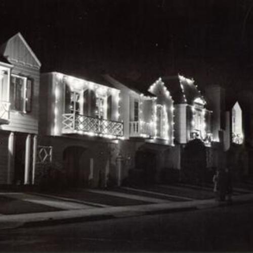 [Houses on 18th Avenue at night, lit up and decorated for holidays]