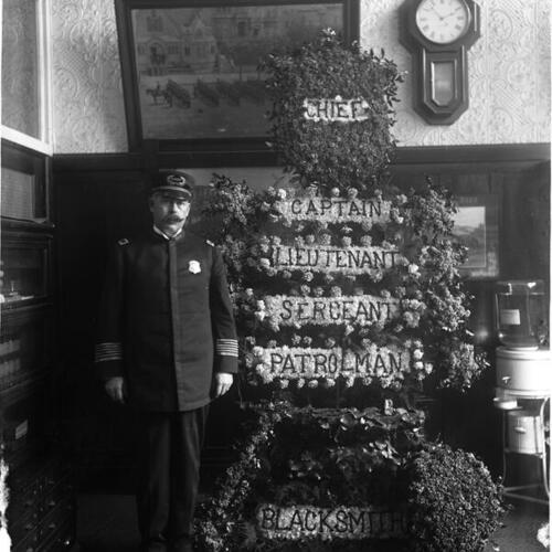 [San Francisco Police Chief with floral arrangement]