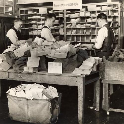 [Postal service employees working at the fast freight room in the Ferry station Post office]