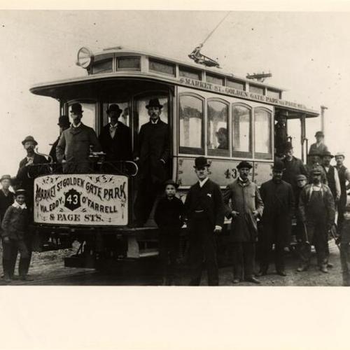 [Group of people posing with a Metropolitan Railway Company streetcar]