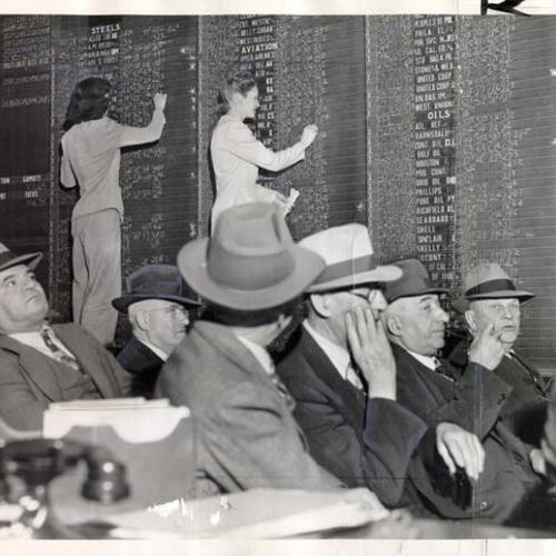 [Traders watching the quotation board at the brokerage house Schwabacher & Co.]
