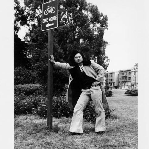 [Haight Ashbury - Brandon Robles leaning against a sign in Panhandle Park]