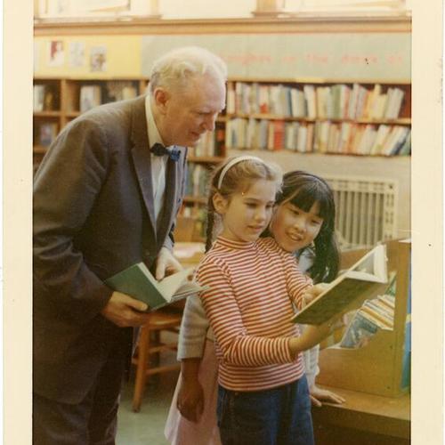 [Stu Boland, staff member of the San Francisco Public Library with two unidentified children]