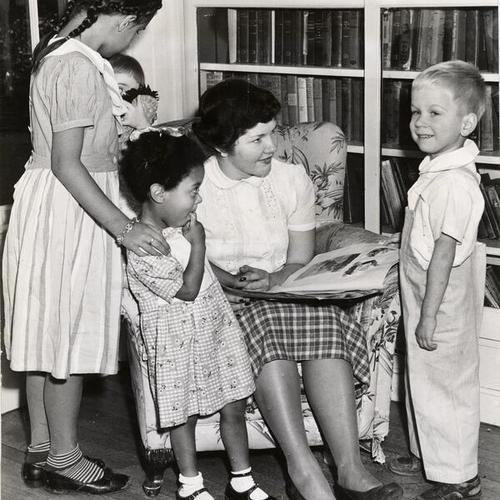[Volunteer Mary Meagher reading to children at the Laguna Honda Children's Home]