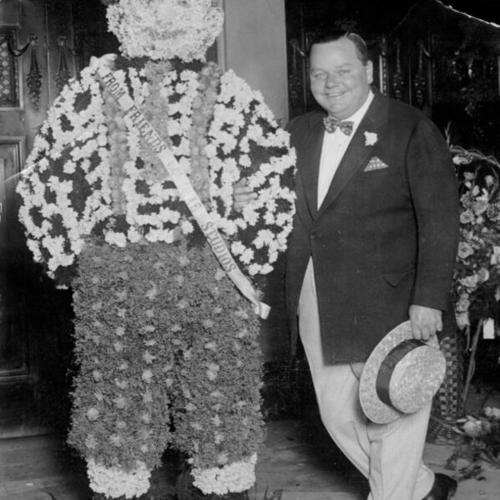 [Fatty Arbuckle poses with a "Floral Fatty"]