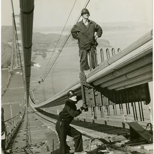[Two construction workers on the Golden Gate Bridge]