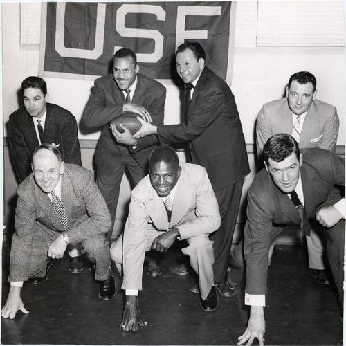 [Former members of the University of San Francisco football team posing during meeting to plan alumni banquet]