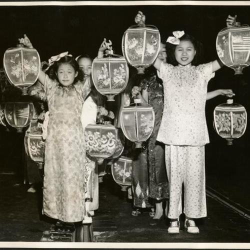 [Florence Chew and Ruby Lee holding lanterns they carried in a parade]