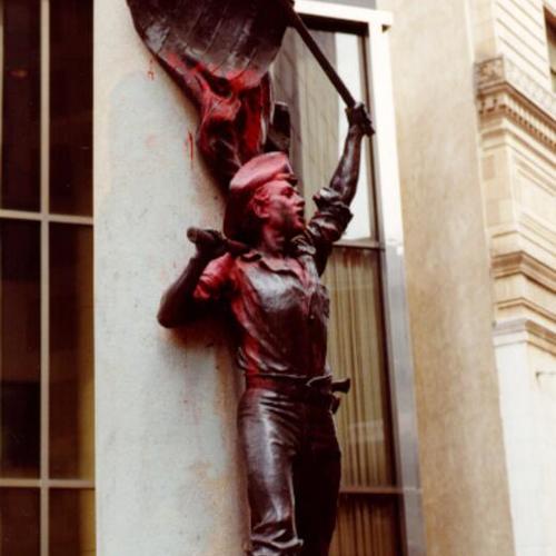  miner from Native Sons Statue doused with red paint on its upper torso, head and on the American flag he is carrying]