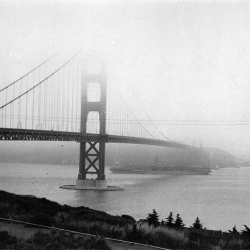 [Unidentified aircraft carrier passing under the Golden Gate Bridge]