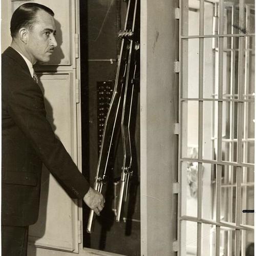 [C.I. Hadley operating one of the levers controlling the doors in tiers of jail cells at San Francisco's new county jail in San Mateo county]