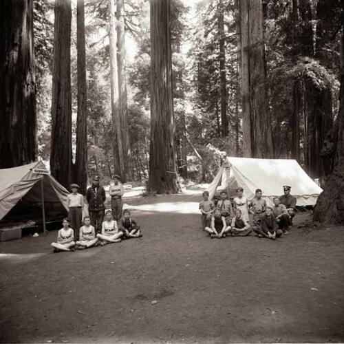 People gather outside their tents at Camp McCoy