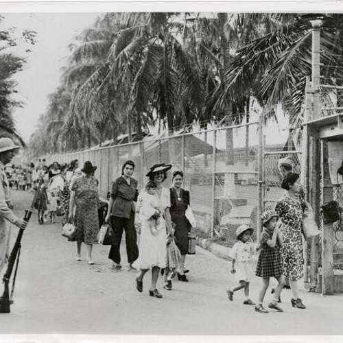 [Women and children leaving an internment camp in the Panama Canal Zone for one in the United States]