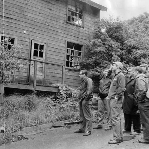 [Group of people viewing an abandoned building on Angel Island]
