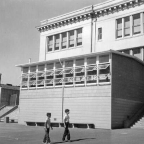 [Bay View School students Robert Estrada and Donald Sanchez looking at a temporary structure on the school's grounds]