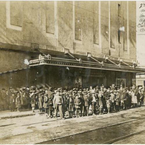 [Group of people standing outside of a theater showing Captain H. J. Lewis' filmed tour of San Francisco's Chinatown]